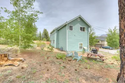a green house with a picnic table and a bench at Mountain-View Eden in South Lake Tahoe