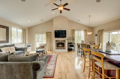 a living room with a fireplace and a dining room at Mountain-View Eden in South Lake Tahoe