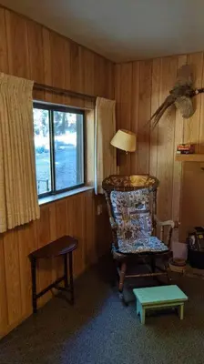 a room with a rocking chair and a window at King's Cabin in Wilsonia