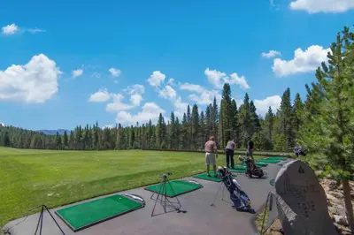 a group of people standing around a golf course at Snowpeak Oasis in Truckee