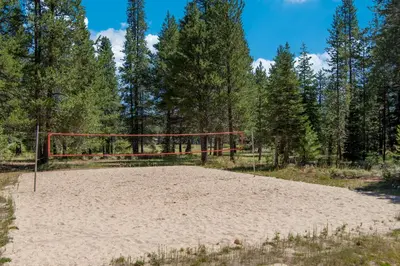 a volleyball hoop in the sand in a forest at Snowpeak Oasis in Truckee