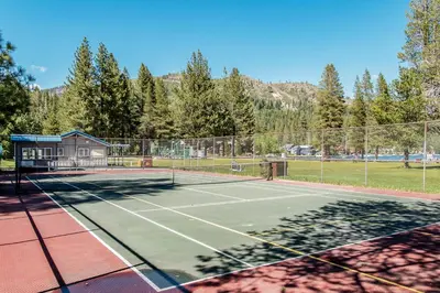 a tennis court with a tennis court at Snowpeak Oasis in Truckee