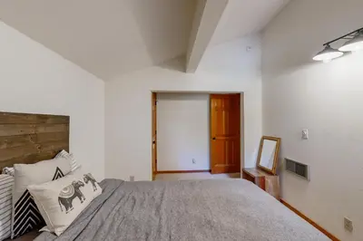 a bedroom with a large bed and a wooden door at Snowpeak Oasis in Truckee