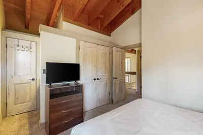 a bedroom with a bed and a flat screen tv at Gold Bend Adventure in Truckee