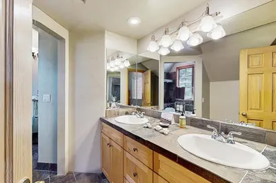 a bathroom with two sinks and a large mirror at Marshall Haven in South Lake Tahoe