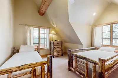 two beds in a room with two windows at Marshall Haven in South Lake Tahoe