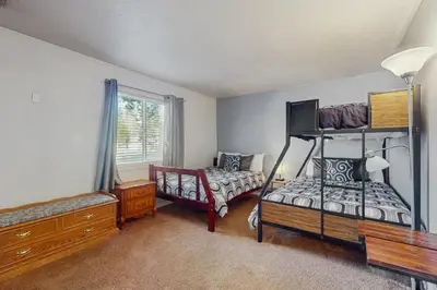 a room with a bedroom with a bed and a chair at Apache Adventures in South Lake Tahoe