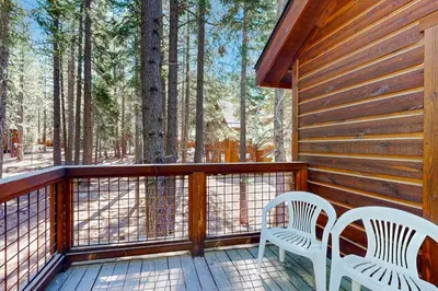 two chairs on a deck with trees in the background at Oslo Oasis in Truckee