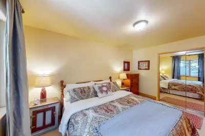 a bedroom with a bed and a mirror at Fawn Haven in Truckee