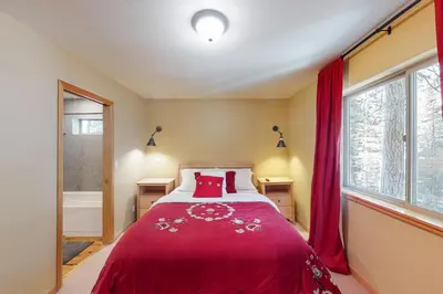 a bedroom with a bed with a red blanket at Fawn Haven in Truckee