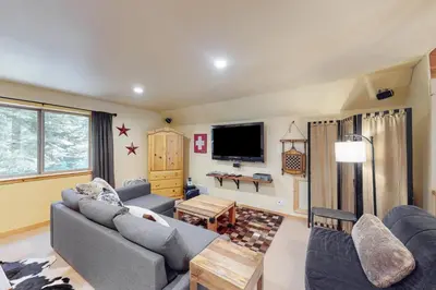 a living room with two couches and a tv at Fawn Haven in Truckee