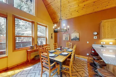 a dining room with a wooden table and chairs at Fawn Haven in Truckee