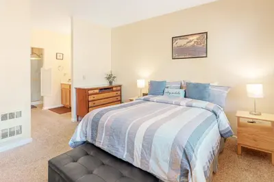 a bedroom with a bed with a blue and white blanket at The Boulders Bldg 2 Unit 3 in Truckee