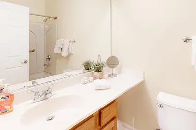 a white bathroom with a sink and a mirror at The Boulders Bldg 2 Unit 3 in Truckee