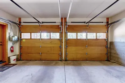 a garage with two wooden doors in a room at Wooded Luxury at Tahoe Donner in Truckee