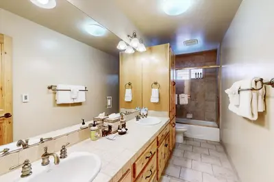 a bathroom with two sinks and a shower at Wooded Luxury at Tahoe Donner in Truckee