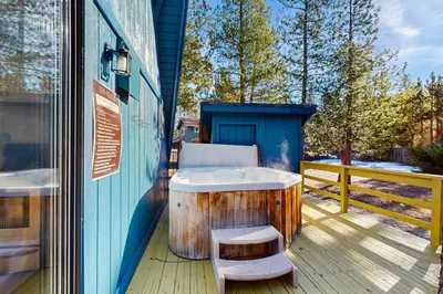 a bath tub sitting on a deck with a bench at Arrowhead Escape in South Lake Tahoe
