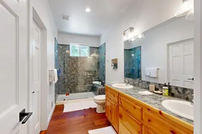 a bathroom with two sinks and a toilet and a shower at Tyrol Getaway in Truckee