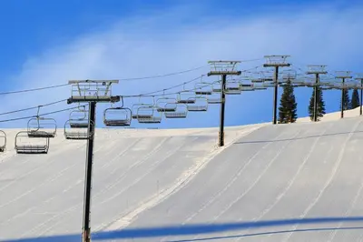 a ski lift on top of a snow covered slope at Tyrol Getaway in Truckee