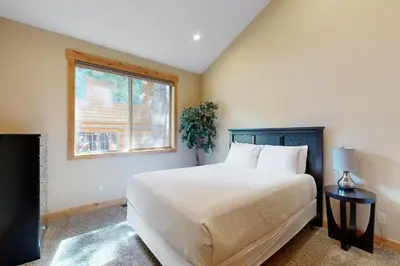 a bedroom with a large bed and a window at Marshall Escape in South Lake Tahoe
