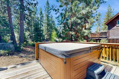 a hot tub on a wooden deck with a bench at Pine Haven in Kings Beach