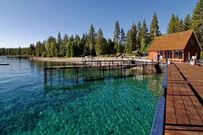 a lake with a dock and a building in the water at Cabin Oasis in Tahoma