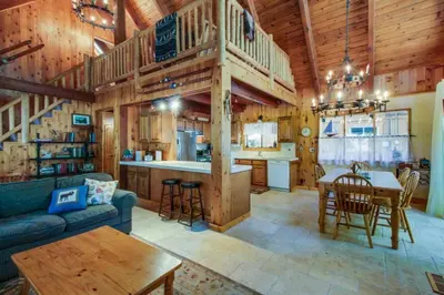 a living room with a couch and a table in a house at Tahoe Pines Cabin in Homewood