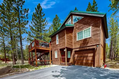 a house with a garage in the woods at Muhlebach Haven in Truckee