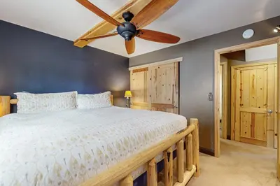 a bedroom with a bed with a ceiling fan at Muhlebach Haven in Truckee
