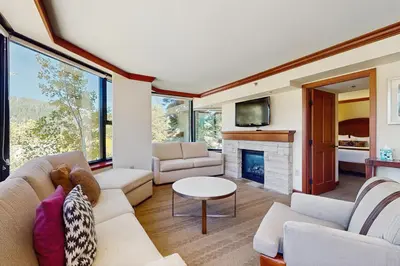 a living room with a couch and a fireplace at Resort at Squaw Creek's 560 & 558 in Olympic Valley