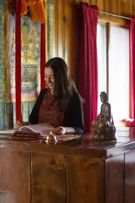 a woman sitting at a desk with a book at Quiet Mind Lodge, Spa & Retreat Sequoias in Kernville