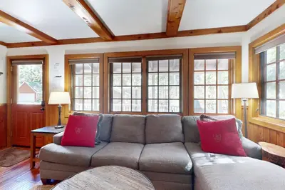 a living room with a gray couch with red pillows at Carnelian Bay Paradise in Carnelian Bay