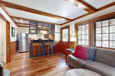 a living room with a couch and a kitchen at Carnelian Bay Paradise in Carnelian Bay