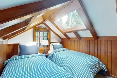 two beds in a room with a window at Carnelian Bay Paradise in Carnelian Bay
