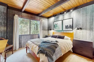 a bedroom with a bed and a desk and a window at Simplon Pass Escape in Homewood