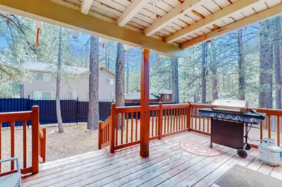 a porch with a grill on a wooden deck at Lone Indian Charms in South Lake Tahoe