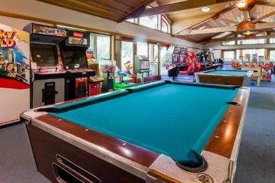 a pool table in a room with arcade games at Ski-In, Ski-Out Designer Condo in Truckee