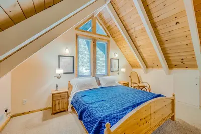 a bedroom with a bed and a window at Cabin in the Woods in Tahoma