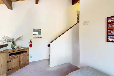 a staircase in a home with a white wall at Ski Bowl Condos Unit 518 in Truckee