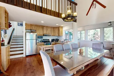 a kitchen and dining room with a glass table and chairs at Ski Bowl Condos Unit 518 in Truckee