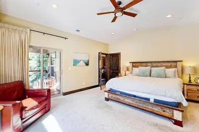 a bedroom with a large bed and a couch at Pooewin Place in South Lake Tahoe