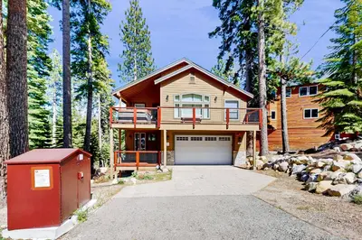 a house in the woods with a garage at Pooewin Place in South Lake Tahoe