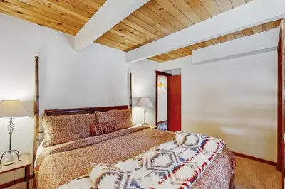 a bedroom with a large bed and a wooden ceiling at Northstar Home in Truckee