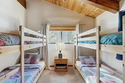 two bunk beds in a room with a window at Northstar Home in Truckee