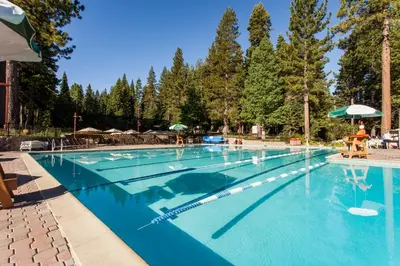 a large swimming pool with blue water at Northstar Home in Truckee