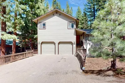 a house with a garage with a driveway at High Meadow Storybook in South Lake Tahoe
