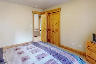 a bedroom with a large bed and a television at Charles Charmer in South Lake Tahoe