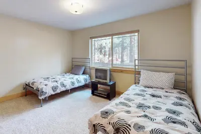 a bedroom with two beds and a window at Charles Charmer in South Lake Tahoe