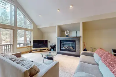 a living room with a couch and a fireplace at Charles Charmer in South Lake Tahoe