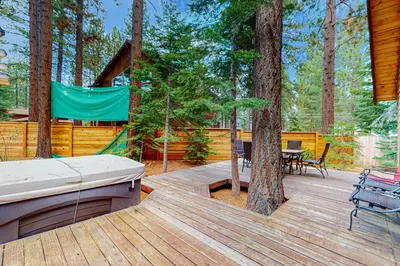 a wooden deck with a hammock and a tree at Montgomery Estates Retreat in South Lake Tahoe